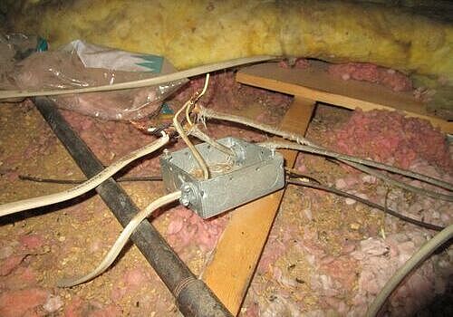 Exposed Electrical Wiring in Attic Creating a Significant Safety Hazard
